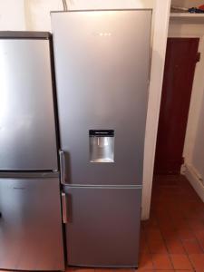 a stainless steel refrigerator with a trash can on it at Traditional House near Liverpool city centre in Liverpool