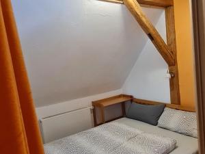 een kleine kamer met een bed en een raam bij Ferienwohnung am Wald in Baiersbronn