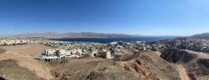 uma vista aérea de uma cidade no topo de uma montanha em פנינת הדקל בבאר אורה em Beʼer Ora