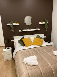 a bedroom with a large bed with a mirror on the wall at Via Piave 82 in Cosenza