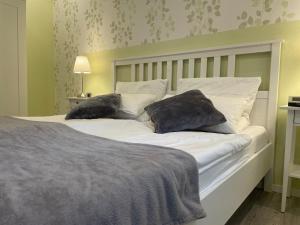 a bedroom with a bed with two pillows on it at Molehill Shire in Hückeswagen
