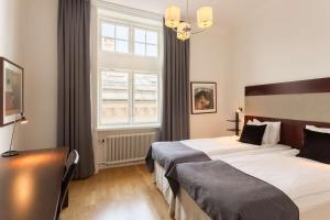 a hotel room with two beds and a window at Scandic Stortorget in Malmö