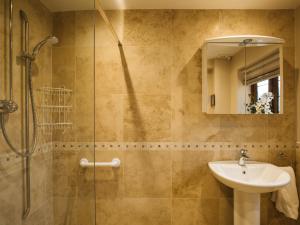a bathroom with a shower and a sink and a mirror at Kingfisher Cottage in Winchcombe +31 photos