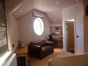 a living room with a couch and a window at Castle Hotel in Aberystwyth