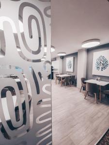 a conference room with tables and chairs and a screen at Pervaža in Panevėžys +34 photos