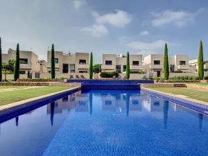 a large blue swimming pool in front of a building at Jardines de Montesolana Penthouse - 2110 in Los Dolses