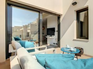a living room with a couch and a table at Jardines de Montesolana Penthouse - 2110 in Los Dolses