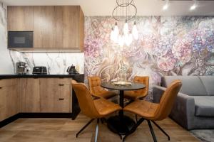 a living room with a table and a couch at Jacuzzi Apartment Main Square in Krakow