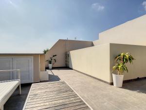 a balcony of a house with two potted plants at Jardines de Montesolana Penthouse - 2110 in Los Dolses