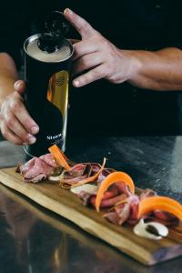 a person is cutting up meat on a cutting board at Masseria Borgo Santuri in Ostuni