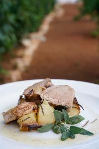 a plate of food with a sandwich on top of it at Masseria Borgo Santuri in Ostuni