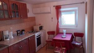 a small kitchen with a table and a microwave at Apartment Balatonbereny 9 in Balatonberény