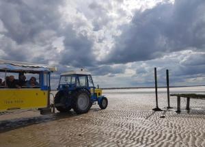 a small vehicle with people in it on the beach at Gites des Sablons in Cherrueix