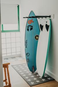 two surfboards are leaned up against a wall at Rocker House, tranquilidad junto a las olas in La Santa