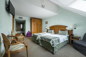 a bedroom with a bed and a desk and a chair at 3 MostA in Saint Petersburg