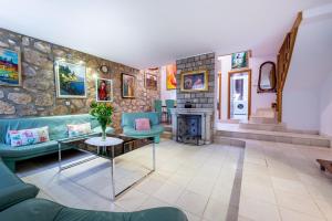 a living room with a stone wall at Villa Mia in Trsteno +71 photos