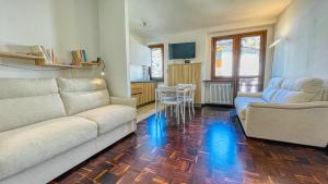 sala de estar con 2 sofás y cocina en Appartamento Winter Garden - Affitti Brevi Italia, en Bardonecchia
