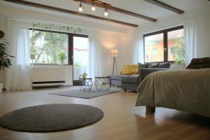 a living room with a bed and a couch at Studio-Apartment mit Garten, Parkplatz & Küche in Offenburg