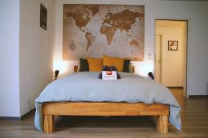 a bedroom with a bed with a map on the wall at Studio-Apartment mit Garten, Parkplatz & Küche in Offenburg