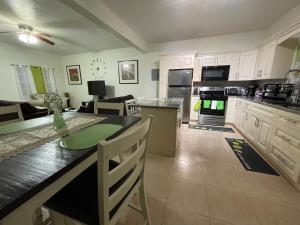 a kitchen with a counter top and a living room at Wintberg Tropical Villas in Mandal