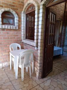 a white table and chairs on a patio at Chalé Rústico in Palmeiras