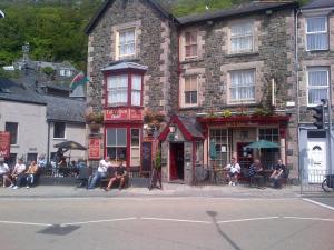 a group of people sitting outside of a building at Tal Y Don Hotel in Barmouth
