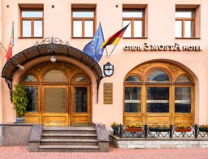 a building with two doors and flags on it at 3 MostA in Saint Petersburg