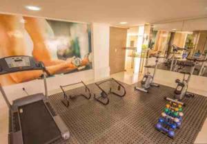 a room with a gym with a treadmill and weights at Luxor Cabo Branco - João Pessoa PB in João Pessoa