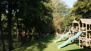 a playground with a slide and a gazebo at Le chalet de Baptiste in Saint-Michel