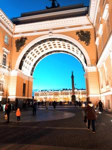 a crowd of people walking under an arch in a building at Sonata at Palace Square in Saint Petersburg