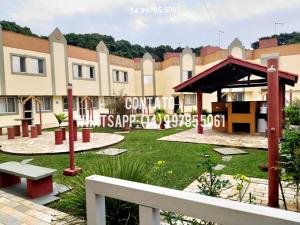 a park in front of a large building at Sobrado para temporada 200m da praia Itapoá SC in Itapoa
