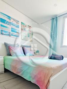 a bedroom with a bed with a colorful bedspread at Paradise Ocean Suite in Adeje