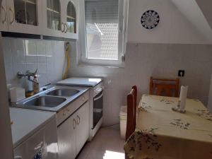 a small kitchen with a sink and a table at Holiday home in Balatonfenyves 18329 in Balatonfenyves +13 photos