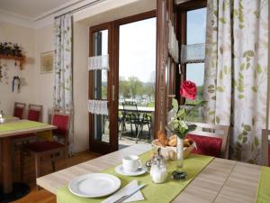 a dining room with a table and a window at Pension Gut Horn in Waging am See