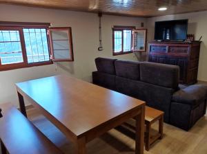 a living room with a couch and a table at Mirador del Navia in Serandinas