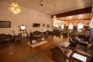 a large living room with couches and a television at Palace Hotel de Caxambu in Caxambu