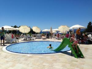 a group of people playing in a swimming pool at Easyatent Luxe Safari tent Krk in Krk