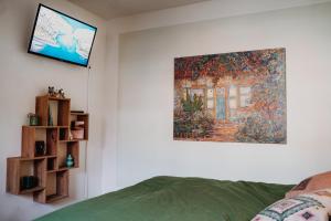 a bedroom with a painting hanging on the wall at Mülheim NEUES Appartment, E-Werk, Palladium, Carlswerk, Messe, Lanxess-Arena in Cologne