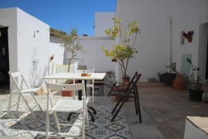 una mesa y sillas en un patio en Casa Leonor Vejer, en Vejer de la Frontera