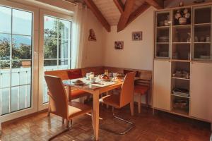 a dining room with a table and chairs at Armonia Altach in Altach