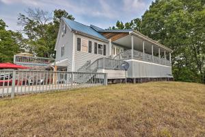 a house on a hill with a fence at Hilltop Hideaway Branson Home with Trampoline! in Branson
