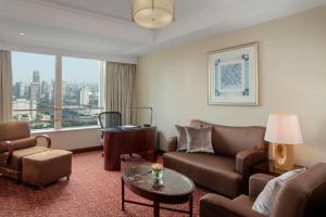 a living room with a couch and a table at Radisson Blu Hotel Shanghai New World in Shanghai