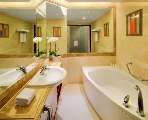 a bathroom with two sinks and a bathtub at Radisson Blu Hotel Shanghai New World in Shanghai