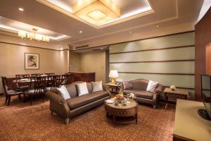 a living room with couches and a dining room at Radisson Blu Hotel Shanghai New World in Shanghai