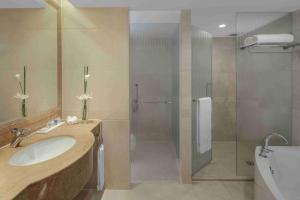 a bathroom with a shower and a sink and a toilet at Radisson Blu Hotel Shanghai New World in Shanghai