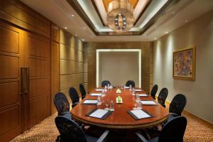 a conference room with a large wooden table and chairs at Radisson Blu Hotel Shanghai New World in Shanghai