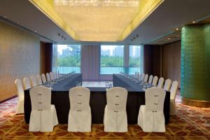 a conference room with a long table and chairs at Radisson Blu Hotel Shanghai New World in Shanghai