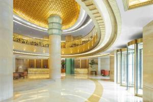 a lobby of a building with a large ceiling at Radisson Blu Hotel Shanghai New World in Shanghai