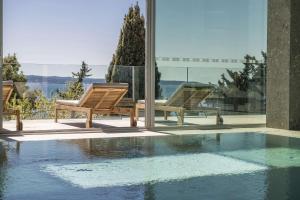 two chairs sitting next to a swimming pool at Radisson Blu Resort & Spa in Split