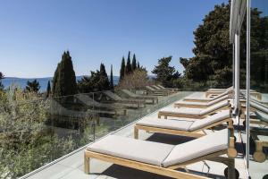 a row of lounge chairs on the roof of a house at Radisson Blu Resort & Spa in Split